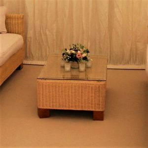 Beige rattan coffee table with glass top