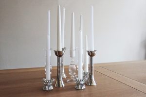 A range of silver and glass candlesticks